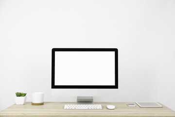 Modern PC Monitor and white screen, mouse, keyboard and some stuff on the wooden table. White background and copy space. Business or Work space theme - obrazy, fototapety, plakaty