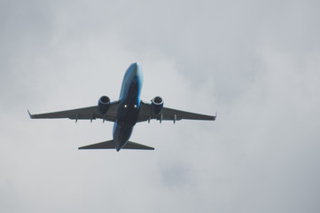 Silhouette of a plane taking off against the blue sky