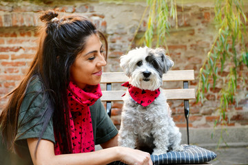 Beautiful Smiling Woman Hugging  Her Cute Havanese Dog with Red Scarf .Fashion for Owner and Dog .