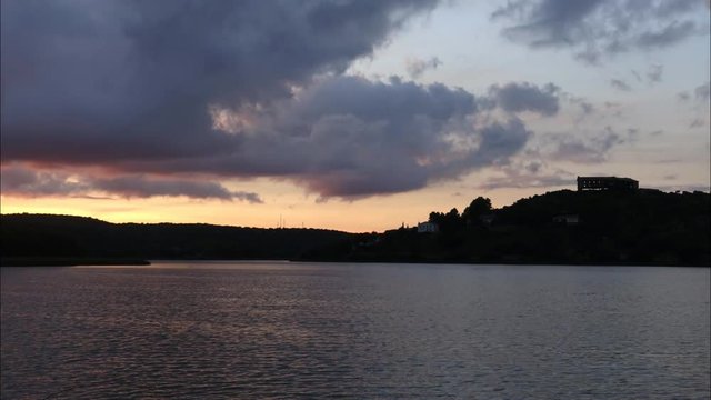 Time lapse on the lake at sunset passing clouds
