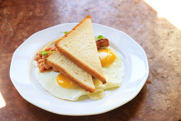 scrambled eggs with beans and toast on a white plate