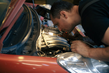 car service, repair, maintenance and people concept - auto mechanic man or smith with clipboard at workshop.