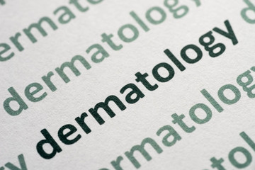 word dermatology printed on paper macro