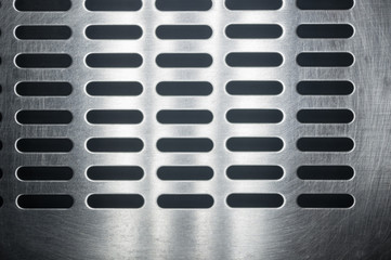 stainless steel grating with oblong holes, close-up