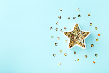 Round colorful sequins in star shape on blue background