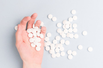 man hand with white pills