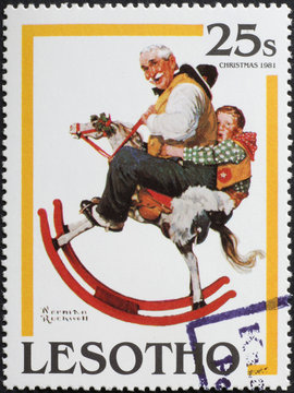 Grandfather and grandchild playing together in Rockwell illustration, postage stamp