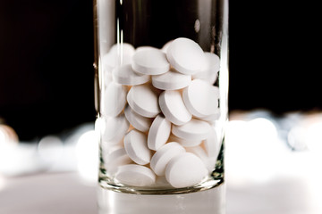 white pills in the glass