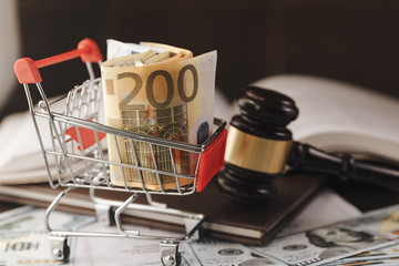 Judge or auction gavel and basket euro banknotes on black background