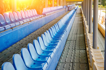 Empty plastic chairs in the stands of the stadium