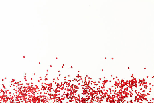 Red confetti on white background