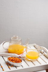 Vitaminic healthy sea buckthorn tea with fresh raw sea buckthorn berries, copy space