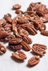 Pecan nuts pile on white background isolated.