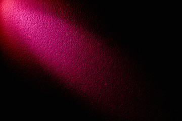 On a black background pink glow across the background