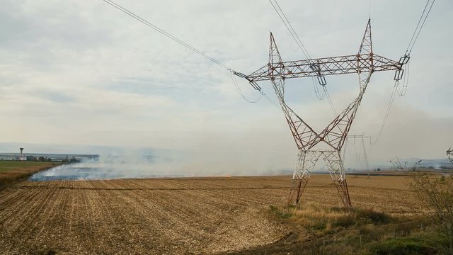 Burning weed on agricultural fields with high voltage pillars