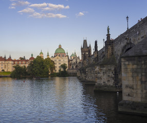 View of Charles Bridge in Prague, Czech Republic. Gothic Charles Bridge is one of the most visited sights in Prague. Architecture and landmark of Prague, golden light, sunny summer day