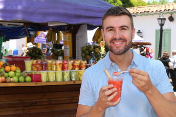 Joyful ethnic male at fruit market