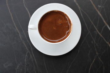 Coffee cup top view, white cup, dark background