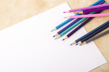Mock up of blank sheet and colored pencils on the table. Place for your design
