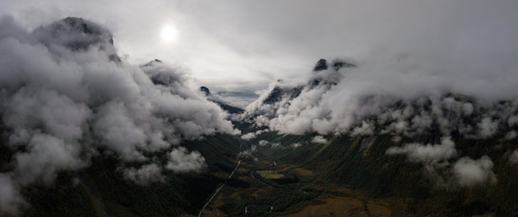 Aerial Drone Panorama view of Large Mountain Covered in Fog, Trees, Forest in Norway