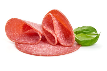 Semi-dry sausage slices with basil leaves and Physalia berry. Isolated on white background. Close-up