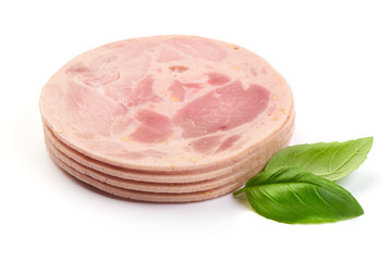 Sliced Fresh Pork ham with basil leaves, close-up, isolated on a white background.