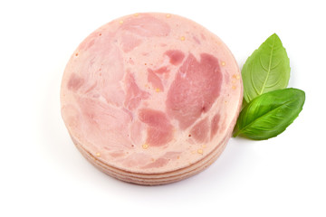Bulgarian Pork Ham slices with basil leaves, close-up, isolated on a white background.