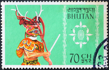 Dancer with ceremonial mask on stamp of Bhutan
