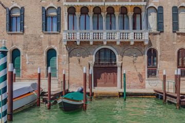Fototapeta na wymiar Venetian house and boats by canal in Venice, Italy