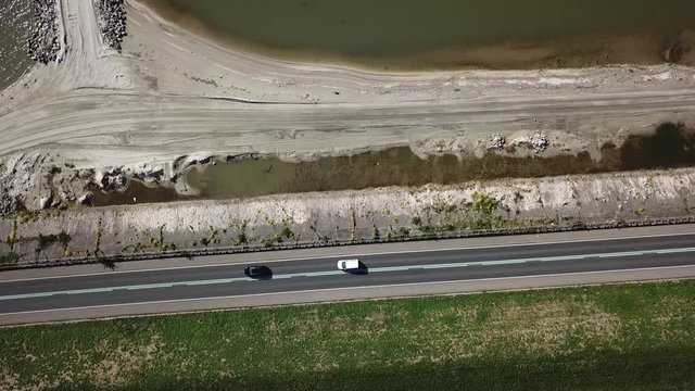 Aerial view of building a nature reserve area in lake Markermeer Holland the Marker Wadden along the dike  cars driving on dike