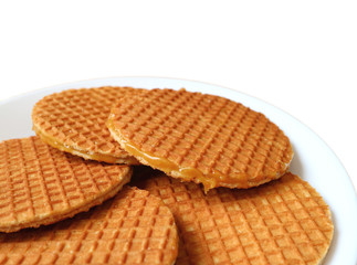 Closed up Stroopwafel Cookies, Tasty Dutch Traditional Sweets Served on White Plate Isolated on White Background with Free Space for Text and Design 