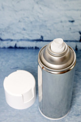 Spray can on a blue background