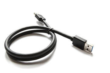 Fototapeta premium Black USB cable on white background. Connector close-up.