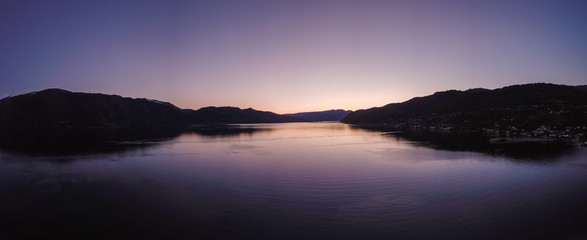 Fototapeta na wymiar Aerial Drone Panorama of Sunset Reflection on Lake in Norway Scandinavia