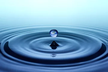 Fototapeten Falling drop of water with earth image © Trutta