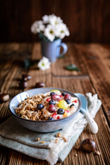 Granola with yogurt, grapes, blueberries, coconut chips and chestnut puree