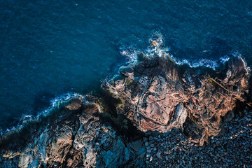 Aerial Top Down over Beautiful Ocean Coast in Scandinavia with Water Crashing against Rocks