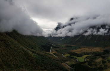 Aerial Drone Panorama view of Large Mountain Covered in Fog, Trees, Forest in Norway