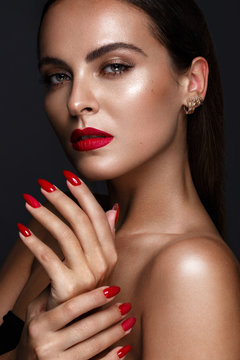 Beautiful girl with a classic make up and multi-colored nails. Manicure design. Beauty face. Photo taken in the studio