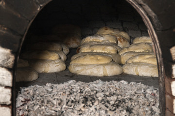 traditional rustic bread cooking on stone charcoal oven
