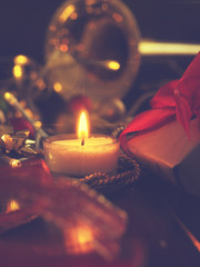 First candle burning with golden decoration