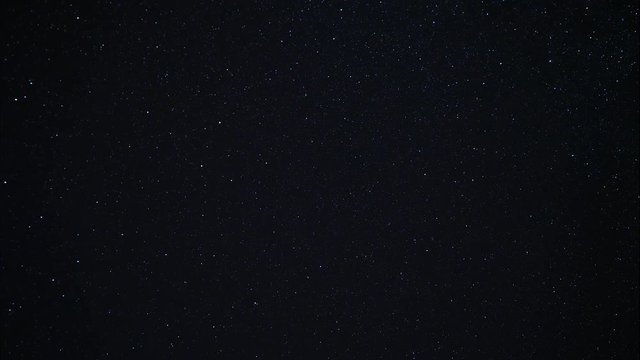 Starry night sky. Twinkling stars in the dark night sky. Starfall on a clear starry sky. Fascinating spectacle. Night sky with nebula. Time lapse