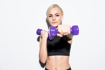 Fototapeta na wymiar Young sporty muscular woman holding dumbbells isolated over white background. Woman in sport clothing exercising