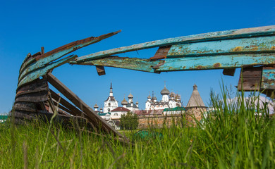 View of  Solovetsky Monastery through a large hole in an old wooden boat on a summer day