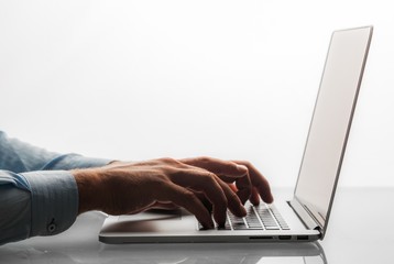 Closeup of a Businessman Typing on a Laptop