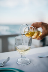 glass of white wine on table in restaurant