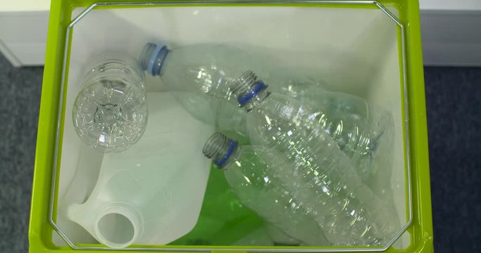 4k overhead timelapse of recycle bin being filled with plastic bottles.