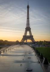 Paris, France - 10 13 2018: View of the Eiffel Tower with water jet from the garden of Trocadero at sunrise