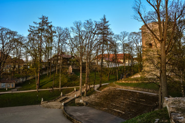 Beautiful afternoon light in public park with green grass and old medieval castle ruins. Shot in Cesis, Latvia.