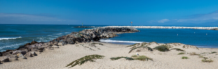 Ventura beach and sea rock wall jetty on the California coastline USA
